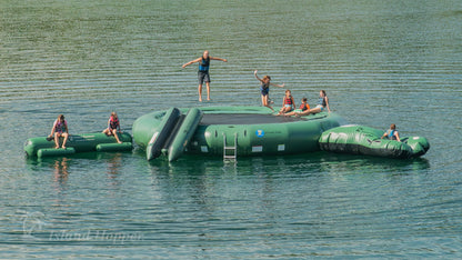 Family on Island Hopper 20ft Acrobat water park natural green steel frame water trampoline on the lake in summer