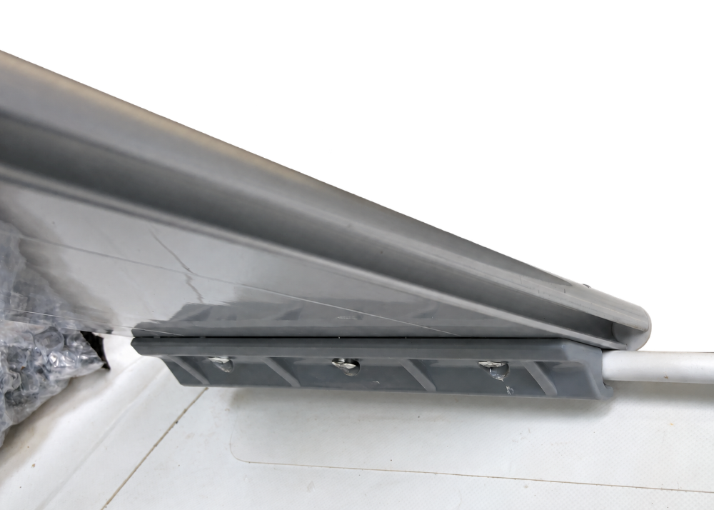 Slide-on bracket riveted to an aluminum bench seat, fitted over the PVC seat rail on an inflatable boat tube