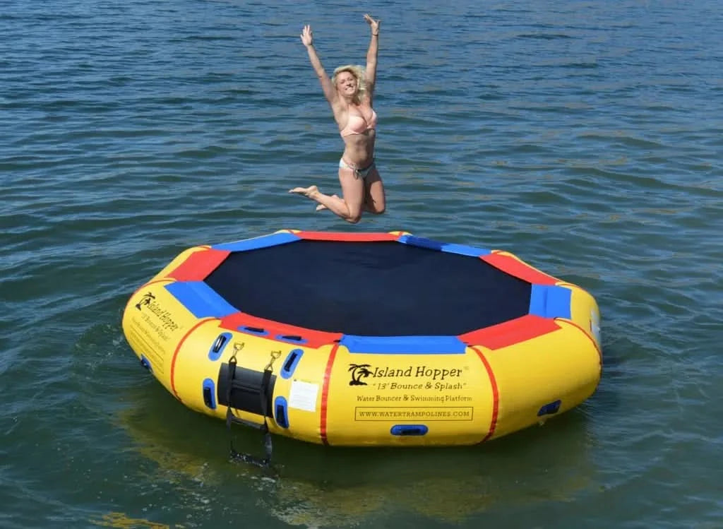 Rider jumping on Island Hopper 13ft inflatable water trampoline water bouncer anchored on a lake