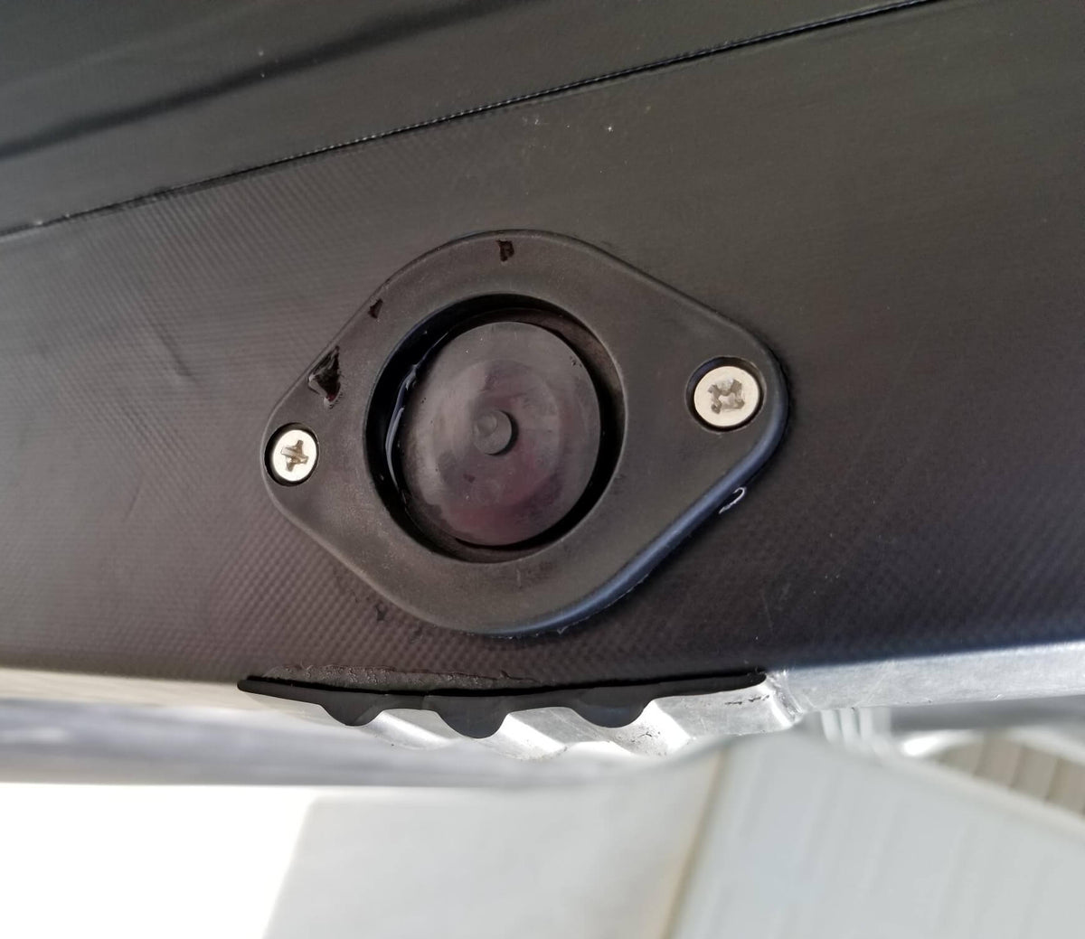 Transom drain port on the outside hull of an inflatable sport boat